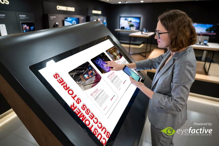 Mesa interactiva con pantallas táctiles PCAP profesionales Sharp para experiencias multitáctiles en entornos corporativos y espacios públicos