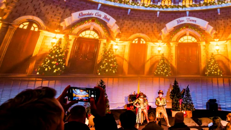 Escenografía navideña proyectada en el interior de la cúpula de ApolloDomes en Gunwharf Quays, con actores en directo y público