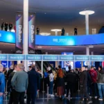 Visitantes ante los accesos de acreditación «Scan & Go» en el vestíbulo de Fira Barcelona Gran Via durante ISE 2026